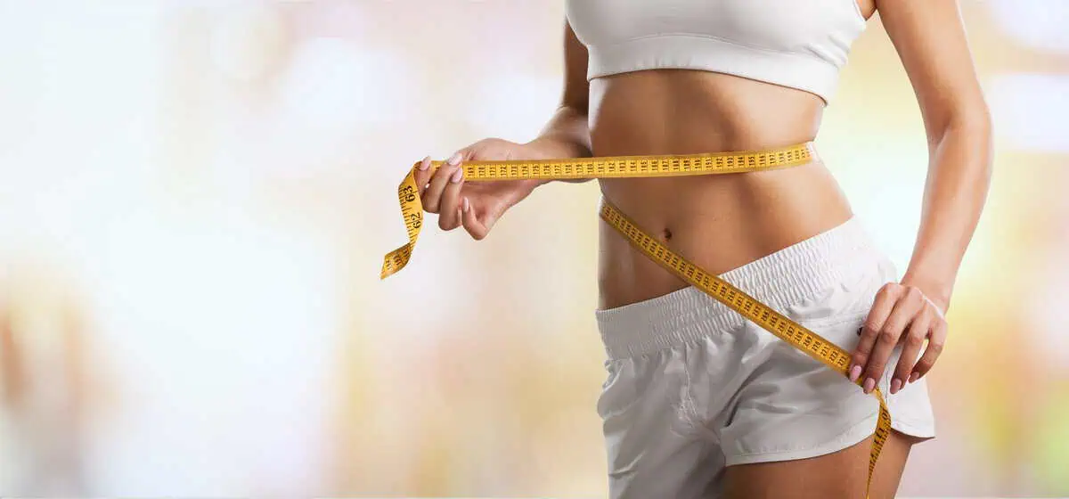 A woman is receiving Abdominoplasty in Alpharetta, GA at The Graivier Center